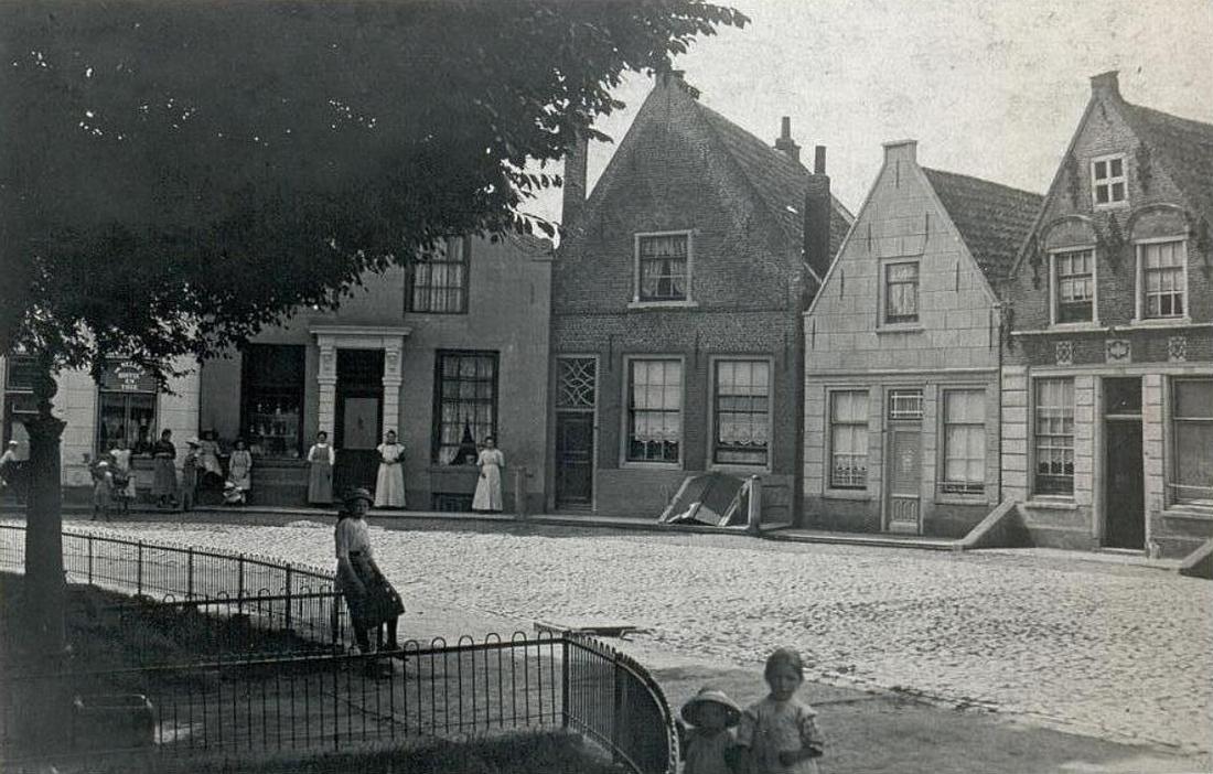 1, Molen 18121 Grutmolen van Zuidland (Zuidland), Links de grutterswinkel op de Ring, ca 1900 | Database Nederlandse molens